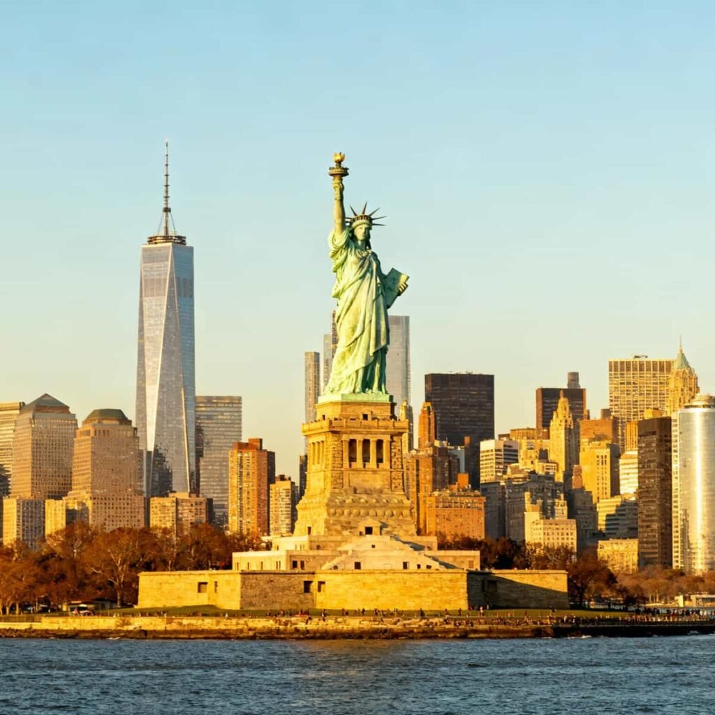 Statue of Liberty & Ellis Island Guided Tour Tickets: The Statue of Liberty on Liberty Island with Manhattan skyline across the water.